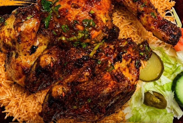 Grilled chicken on spiced rice with salad